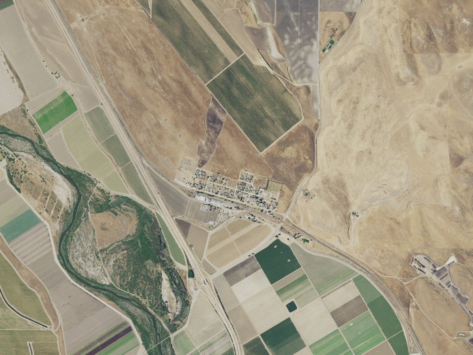 Aerial view of San Lucas, a small cluster of homes surrounded by farm fields, dry hills and the Salinas River, with no other town in sight